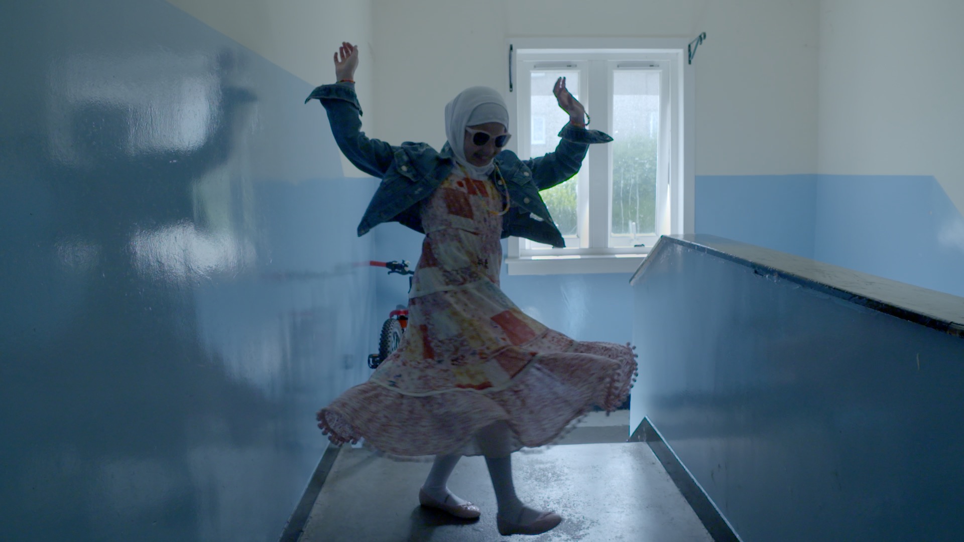 Still from Isle Of Us. A woman dancing in a corridor