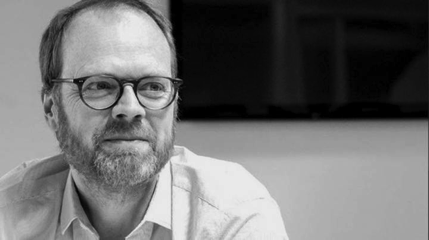 Black and white photo of a man with glasses 