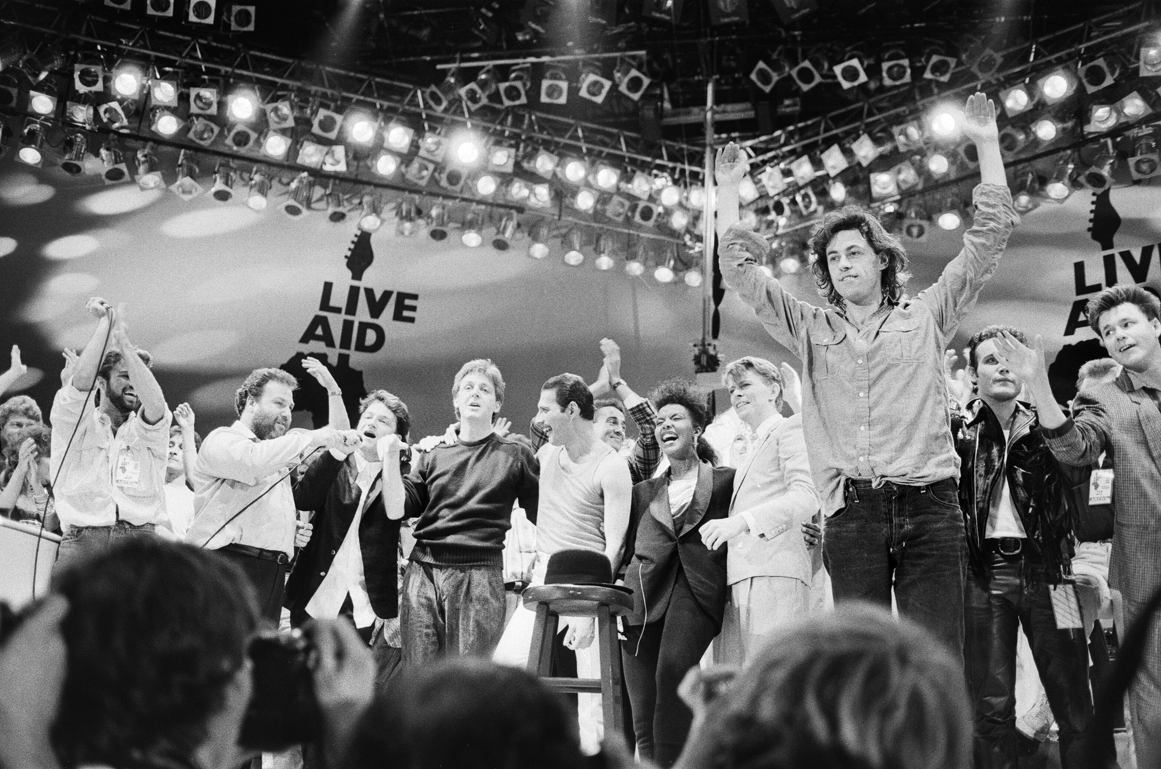 A shot featuring Sir Bob Geldof and other popstars from the film Live Aid at 40 – When Rock'N'Roll Took on the World