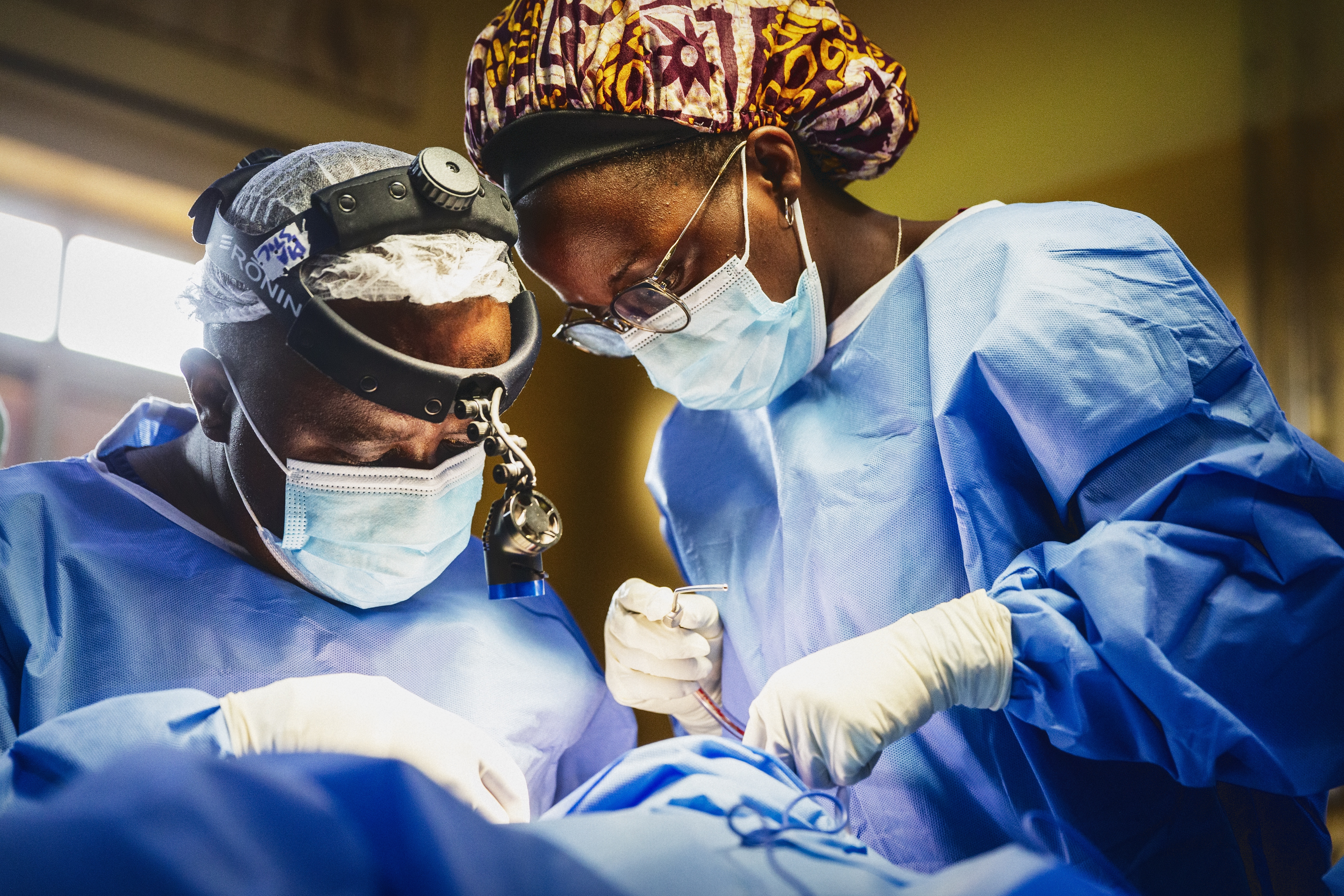 The Surgeon leading images. Two doctors in scrubs performing surgery. 