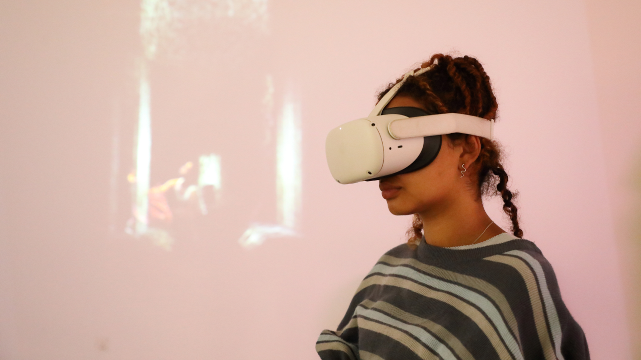 Audience member experiencing an immersive work, wearing a VR headset.