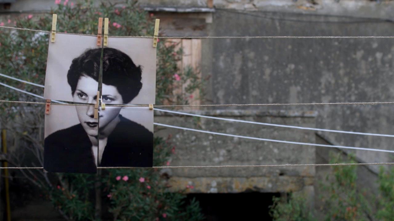 Four photos are pegged to a clothes line, creating a black and white portrait of a woman. 