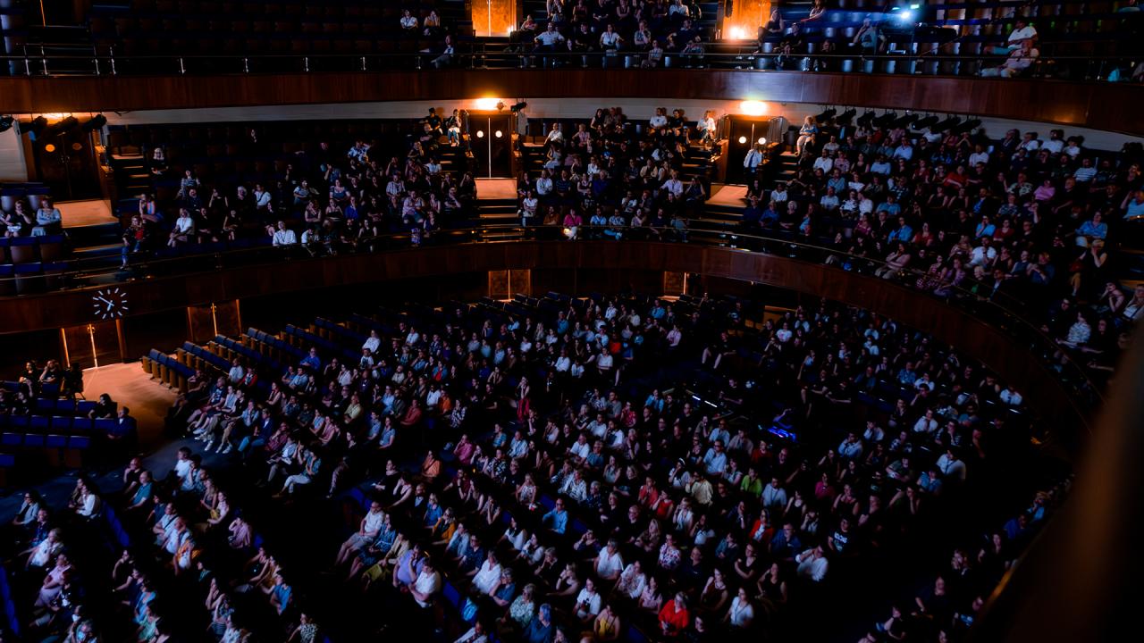 Aerial view image of a full theatre auditorium. 
