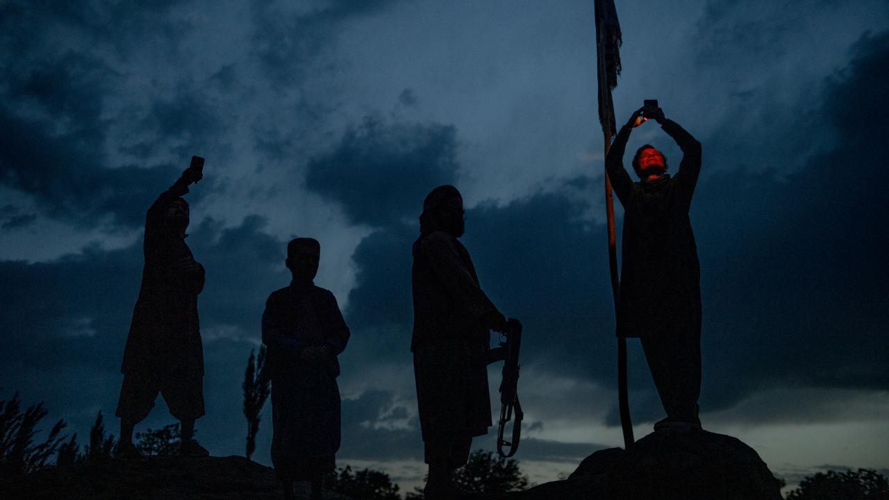 Silhouettes of four people stood under the evening sky in the documentary film Transition