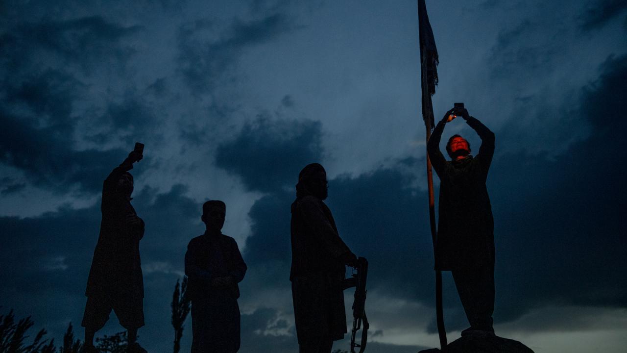 Silhouettes of four people stood under the evening sky in the documentary film Transition