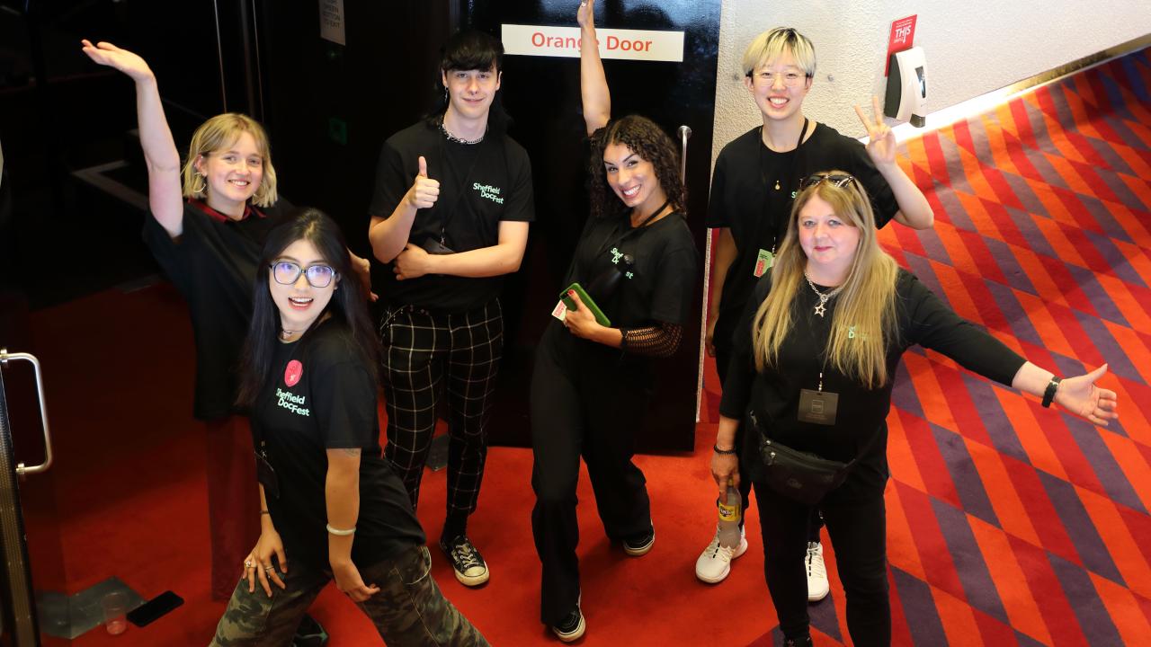 Six members of the 2023 volunteer team wearing black DocFest tops 