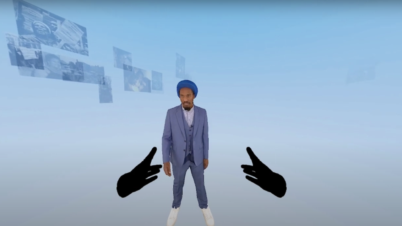 A man stood in front of a light blue background wearing a light blue suit. Two dark digital hands reach out towards him.