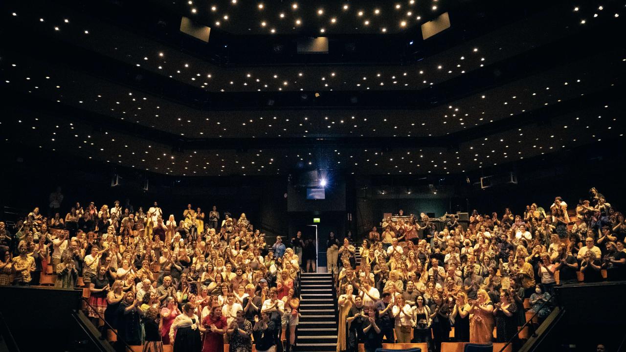 A large crowd stand to applause at the Crucible Theatre.