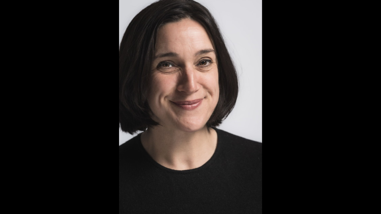 Headshot of Jo Hunter. She is smiling, wearing a black top with short black hair.
