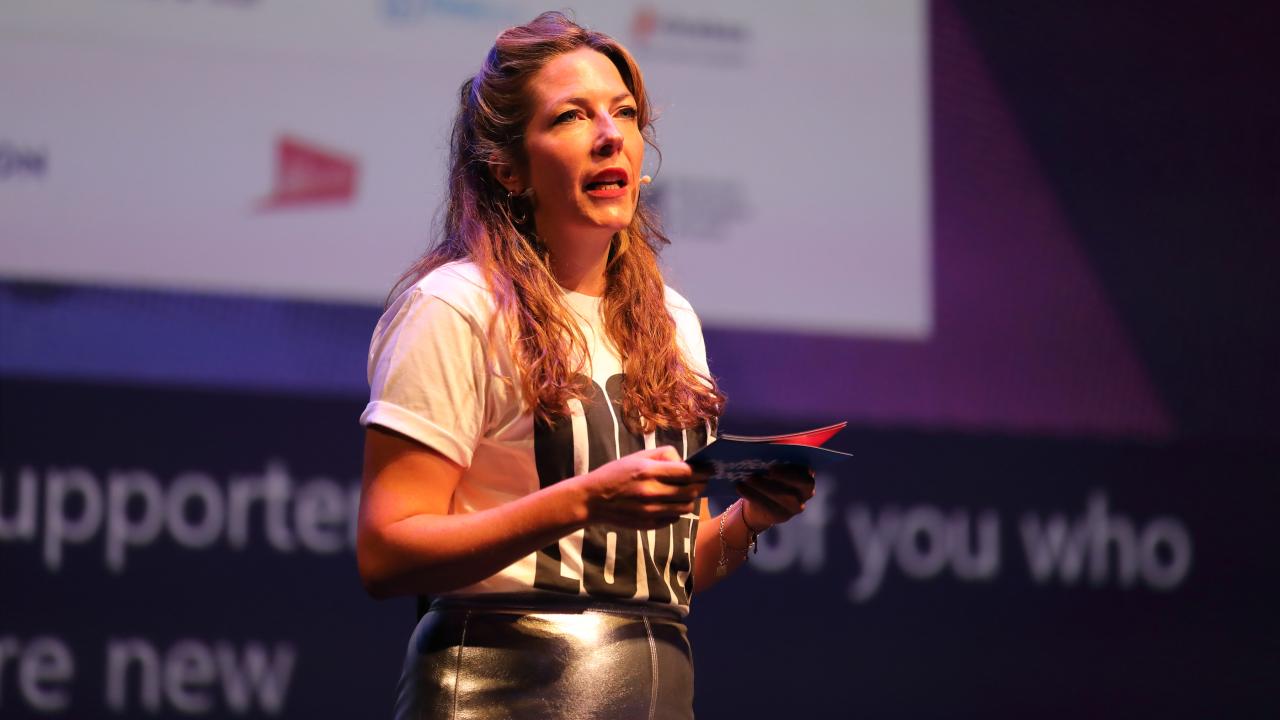A woman presents a speech at an event.