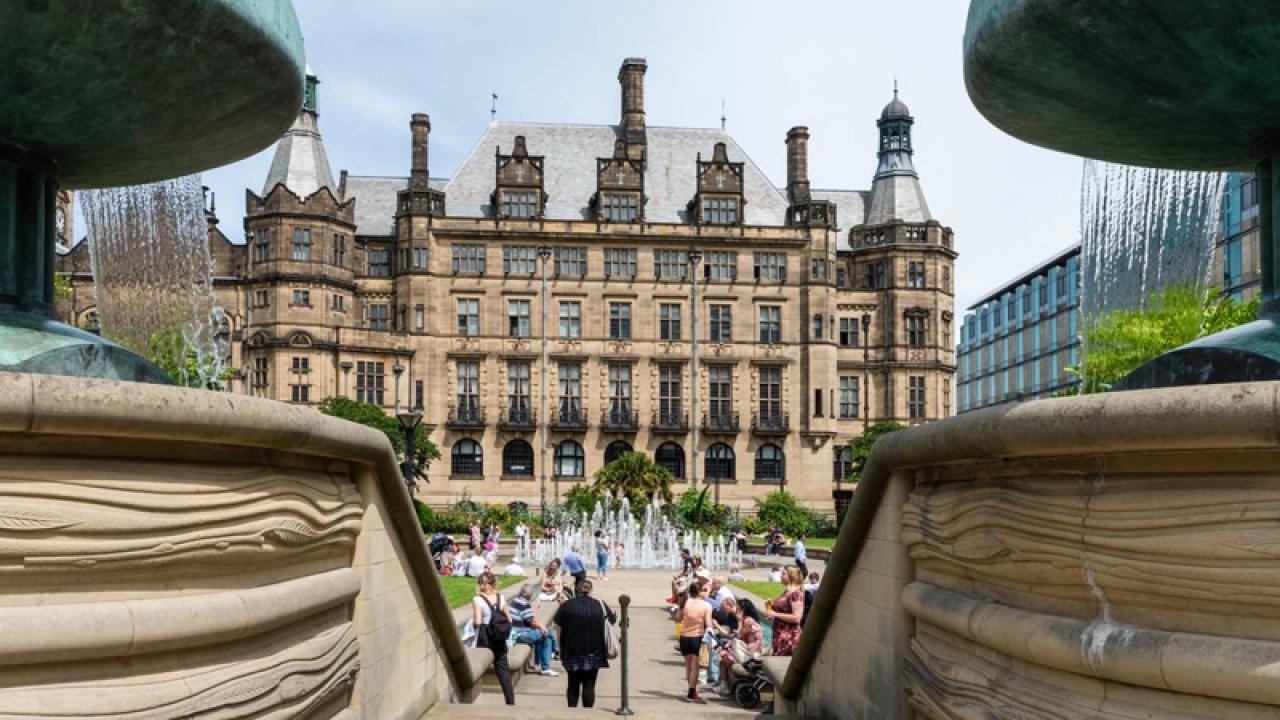 A group of people in the middle of a square in Sheffield.