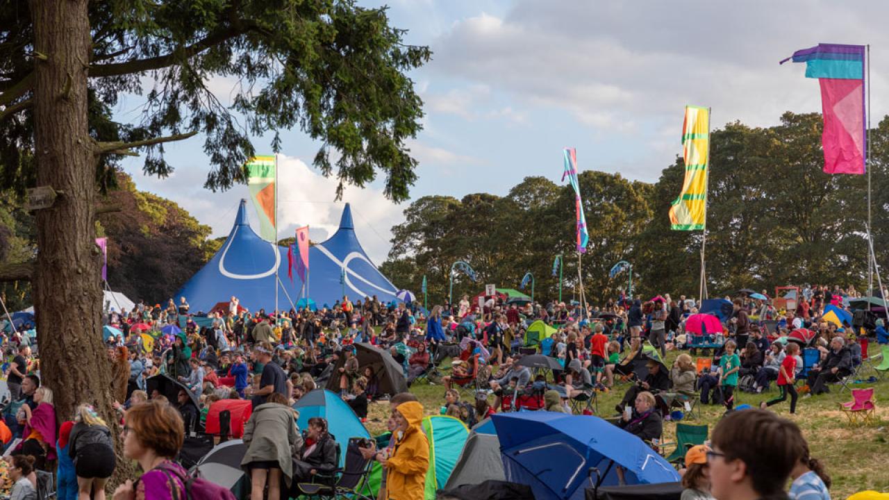 People gather together at an outdoor music festival called Deer Shed.