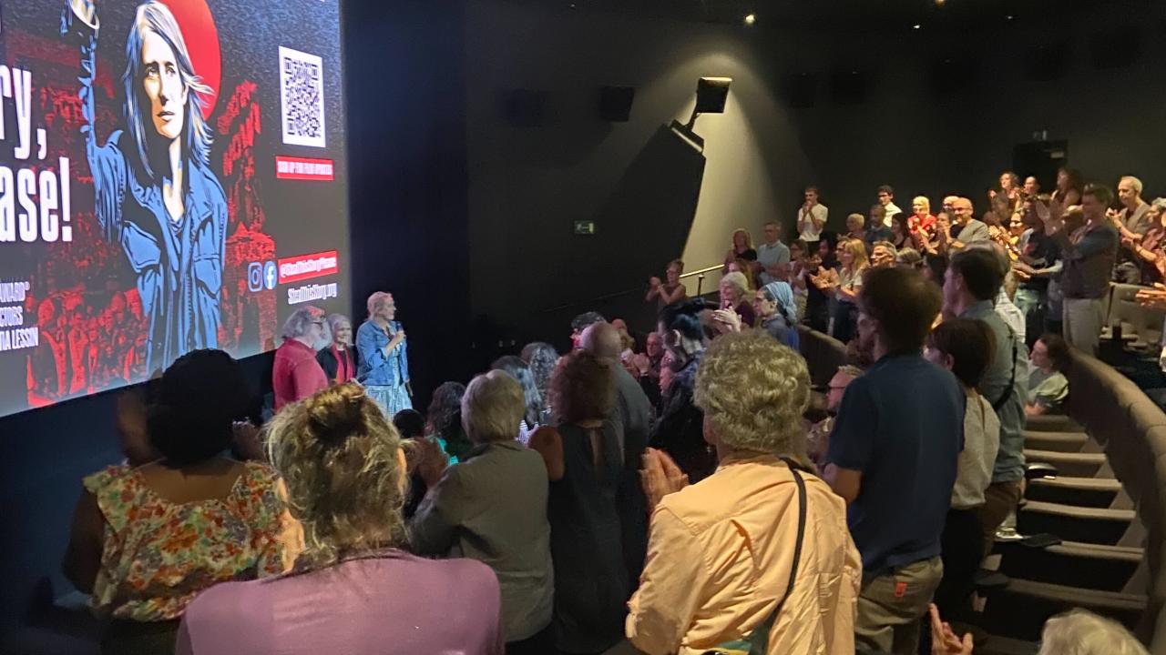 An audience claps at the end of a film.