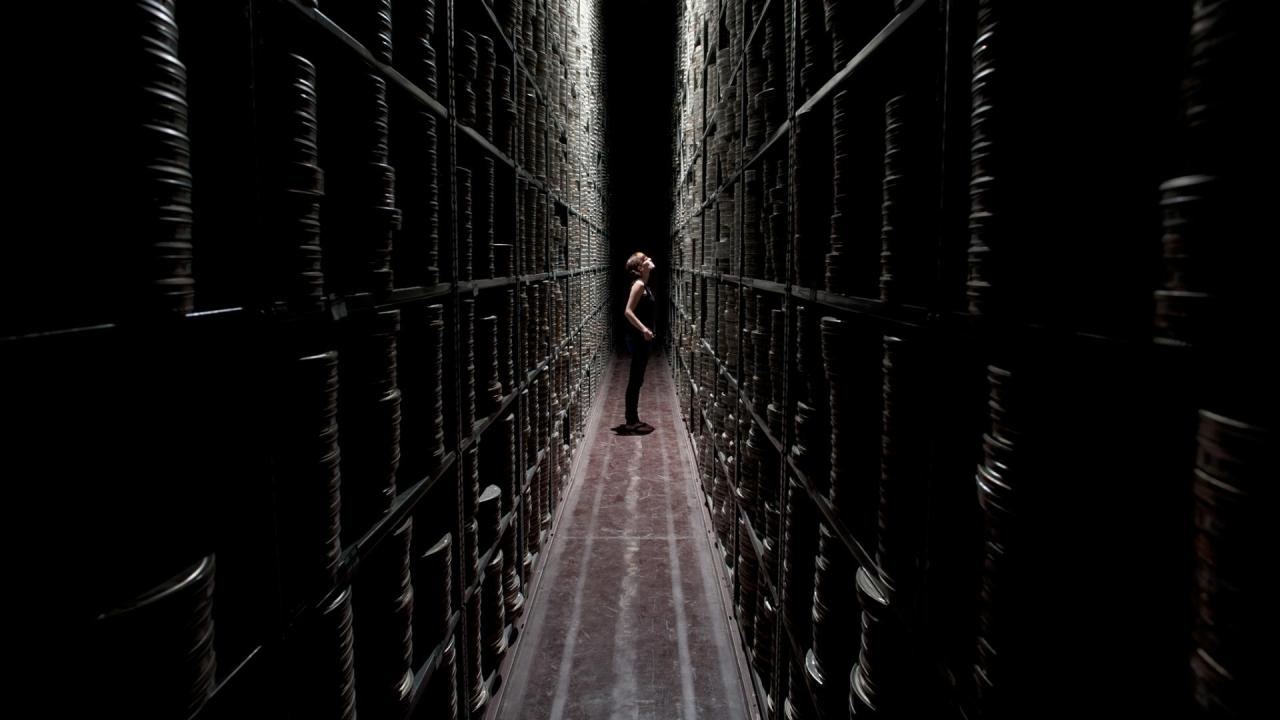 bfi-national-archive-berkhamsted-woman-stacks-corridor.jpeg