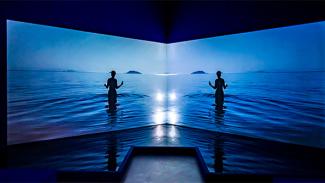 Two screens with silhouette of a person in deep blue sea