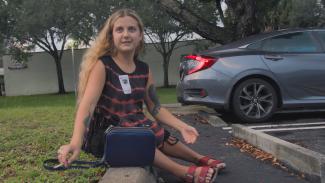 ITAOT_Still05_Ella_Glendining_sits_outside_hosptial_in_USA_Annemarie_Lean_Vercoe.png